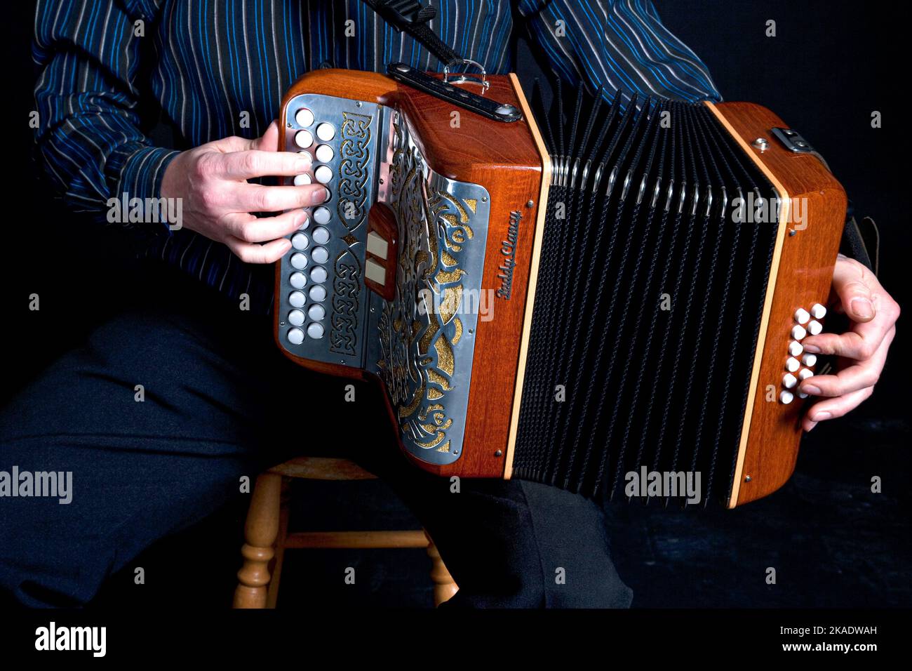 Irish 3 row button accordion being played Stock Photo