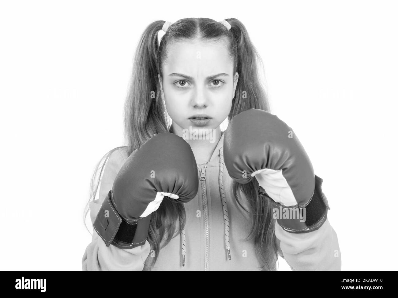 serious kid boxer in boxing gloves ready to fight and punch isolated on