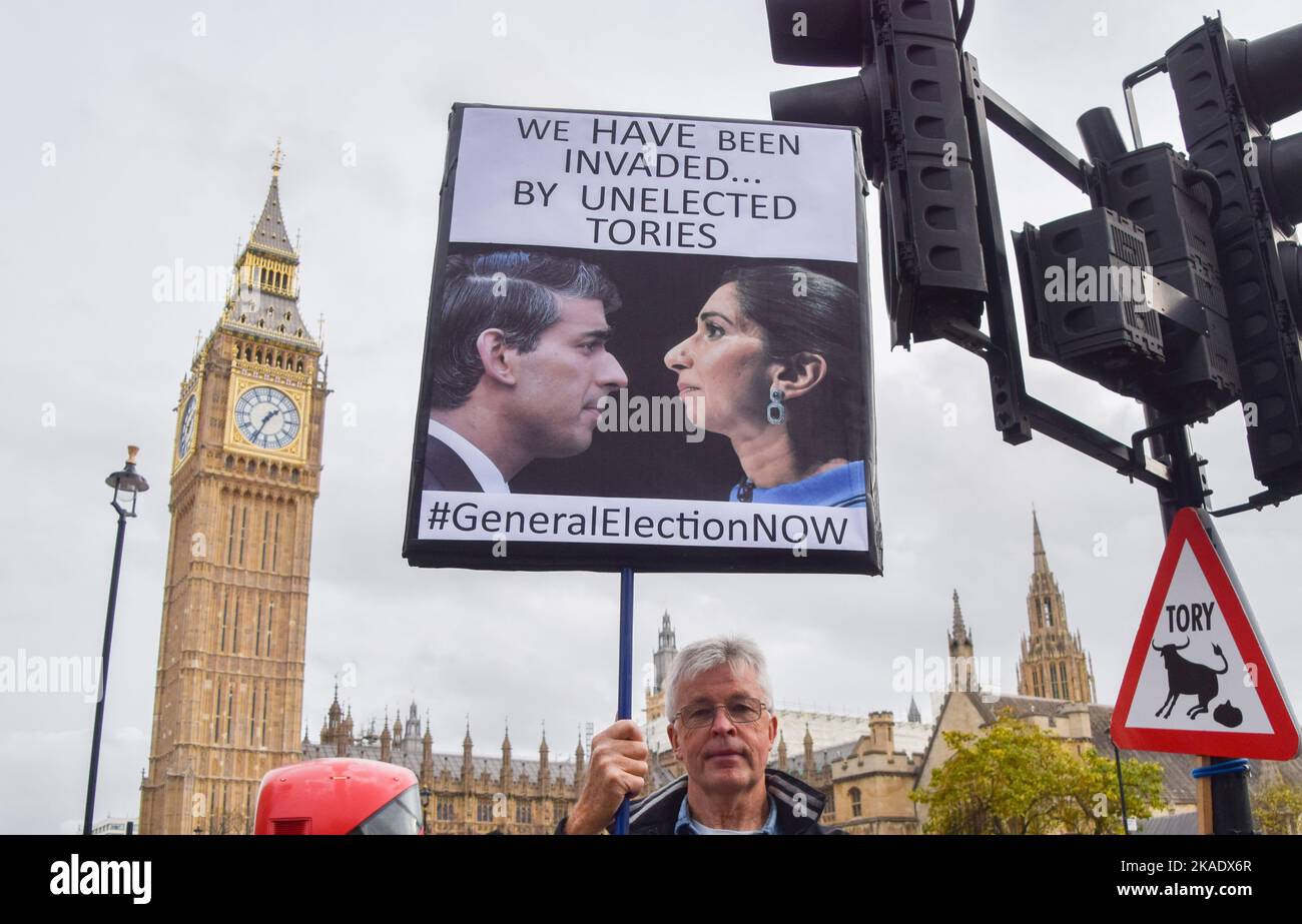 London, England, UK. 2nd Nov, 2022. A protester holds a placard with a picture of Prime Minister Rishi Sunak and Home Secretary Suella Braverman, and a reference to Braverman's recent controversial remarks about the 'invasion' of migrants in the UK. Protesters gathered outside Parliament as Rishi Sunak faced Prime Minister's Questions. (Credit Image: © Vuk Valcic/ZUMA Press Wire) Stock Photo