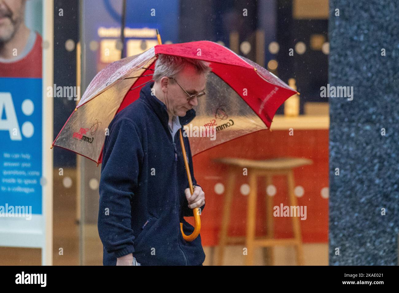 Preston, Lancashire. UK Weather. 2 Nov 2022. Very wet and windy in the city centre as heavy rain and strong winds move in from the south-west. Strong gusts at times drenched shoppers, and broke umbrellas. Credit; MediaWorldImages/AlamyLiveNews Stock Photo