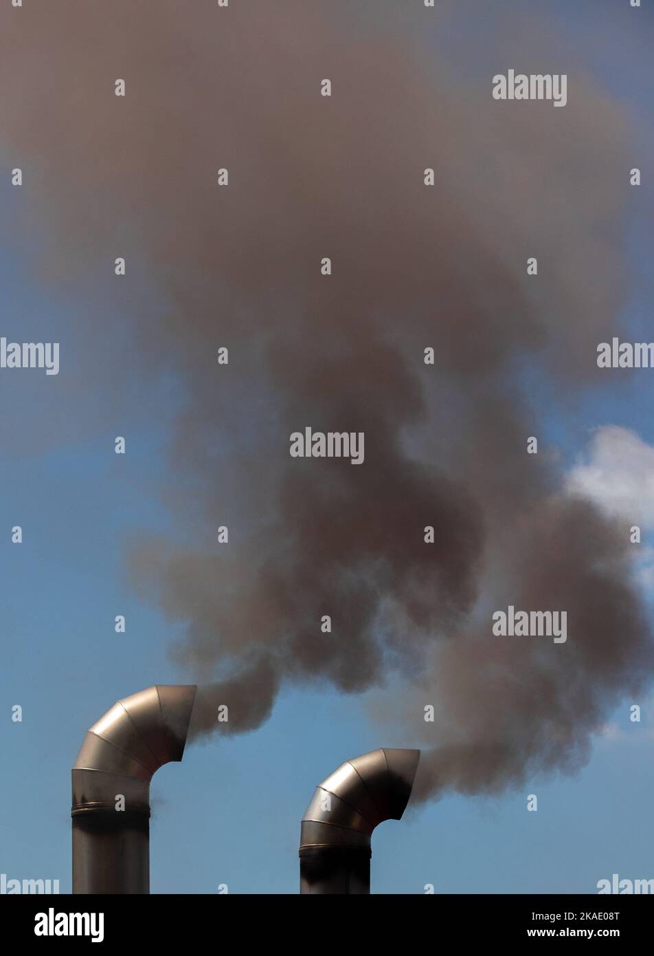 Smoke coming out of two chimneys, toxic, pollution Stock Photo