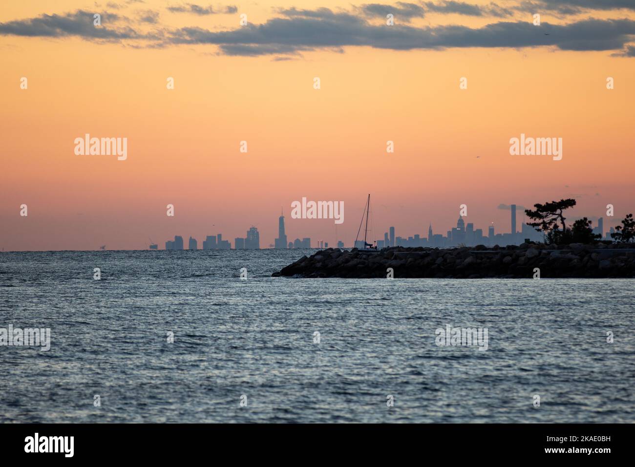 A breathtaking sunset view over the ocean with the New York City ...