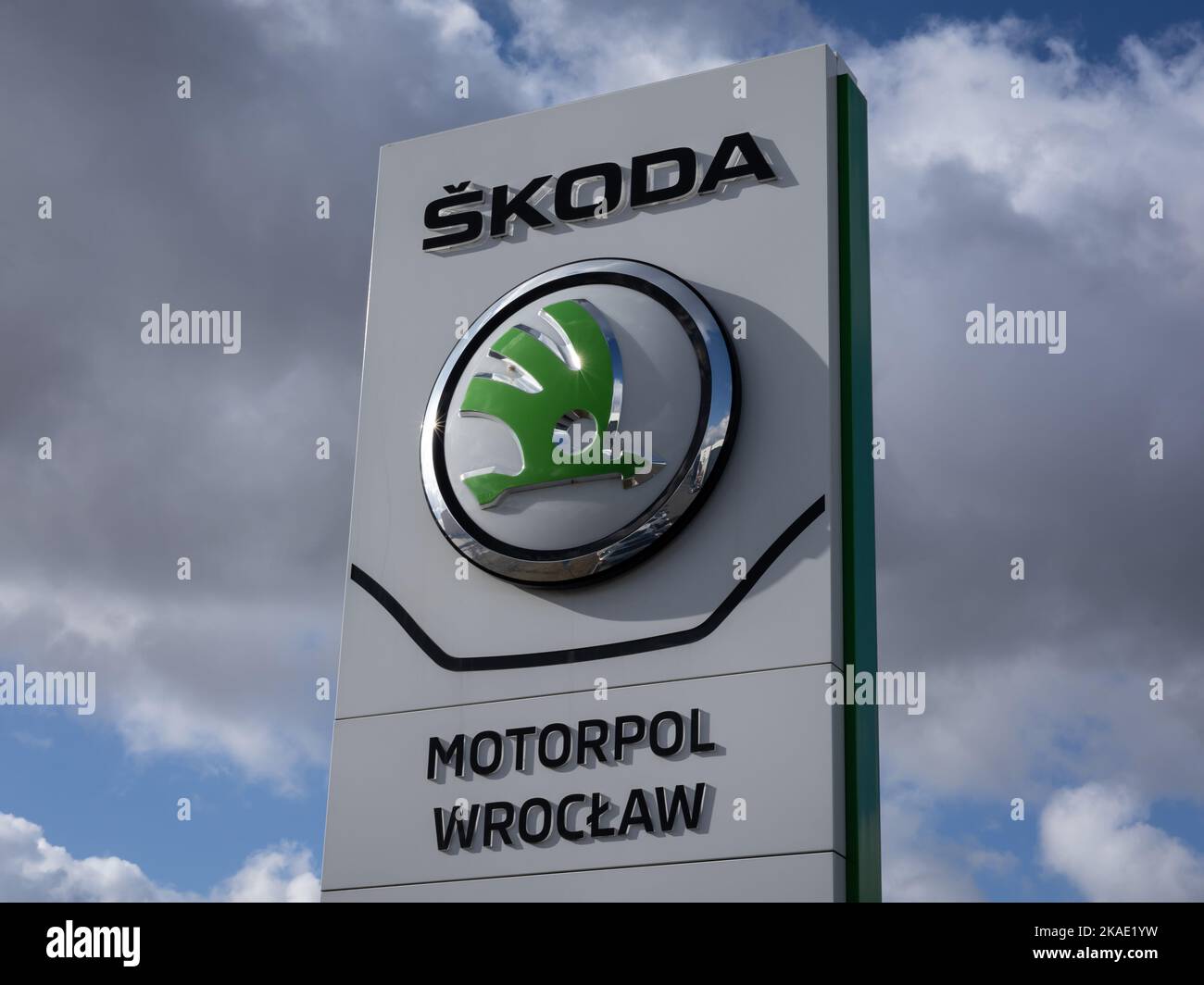 Wroclaw, Poland - February 19, 2022: Closeup of a column with an emblem of Skoda Auto, Czech  automobile manufacturer. No people, cloudy sky. Stock Photo