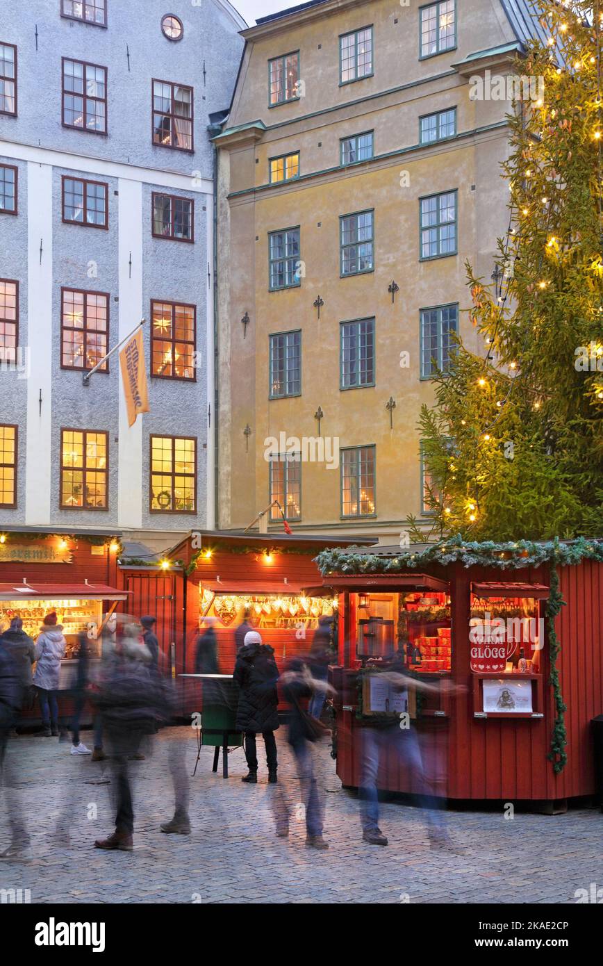 Traditional Christmas market at Stortorget in Gamlastan (old town), Stockholm, Sweden, at dusk with blurred people Stock Photo