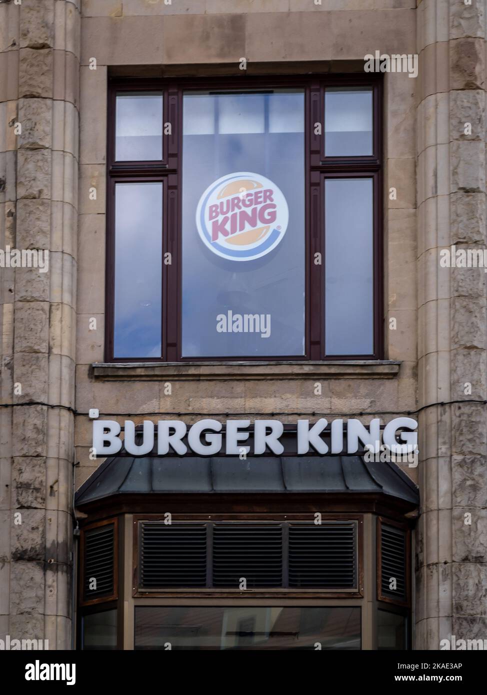 Wroclaw, Poland - February 19, 2022:  Burger King fast food restaurant logo on a wall of a historical building in old town square. Stock Photo