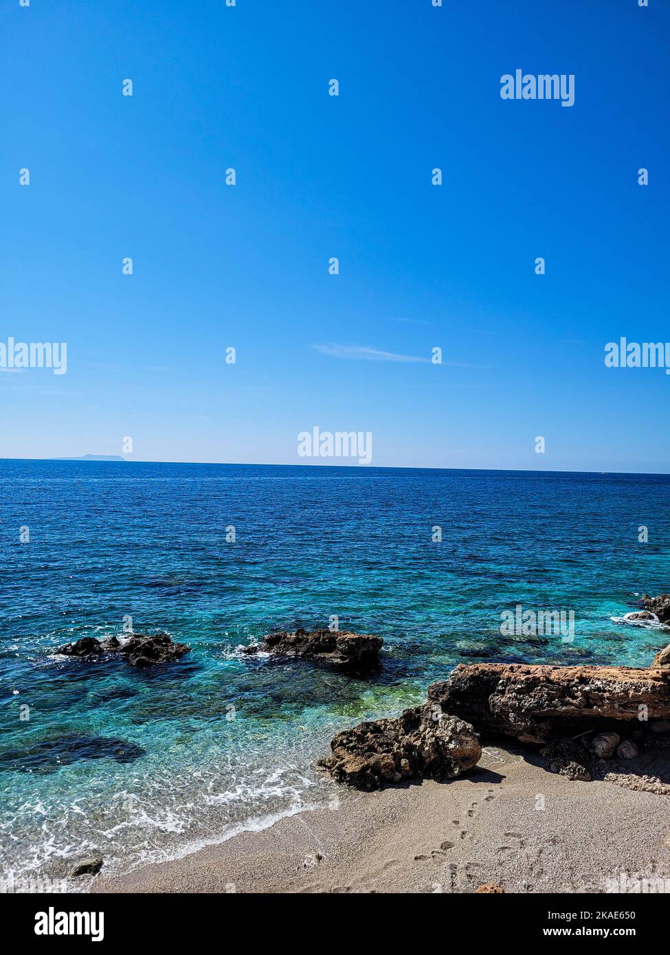 Beautiful seascape view with rocky sandy shore with and waves of calm ...