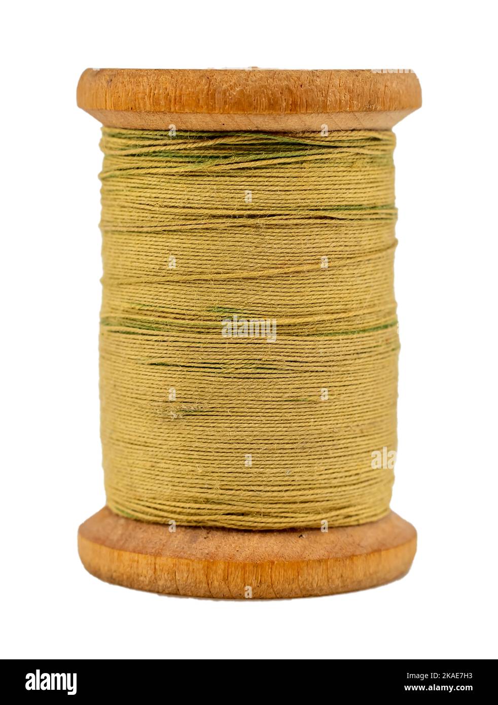 Old wooden spool of thread for sewing closeup. Threads on a white