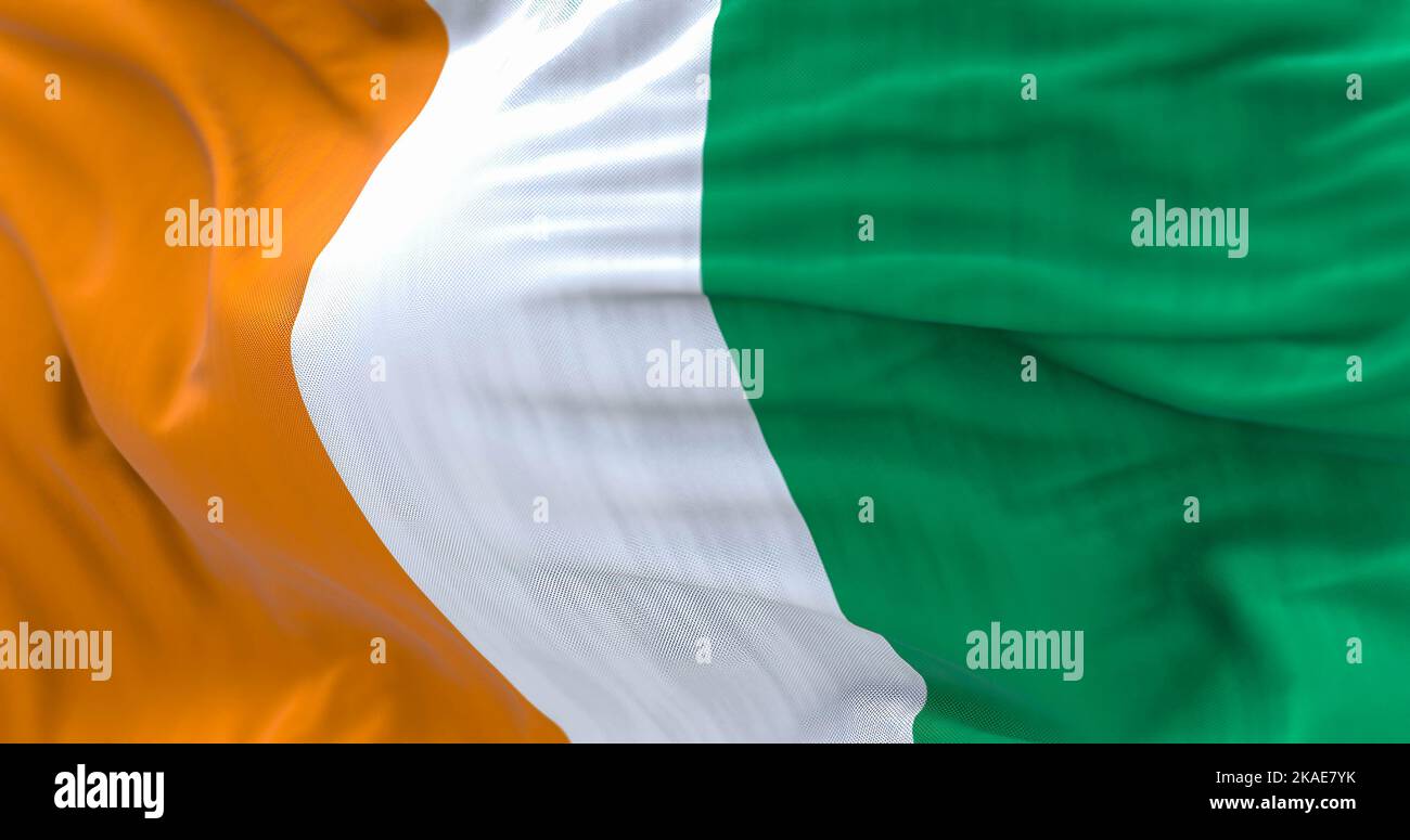 Close-up view of Ivory Coast National flag waving. The Republic of Ivory Coast is a West African State. Fabric textured background. Selective focus. 3 Stock Photo