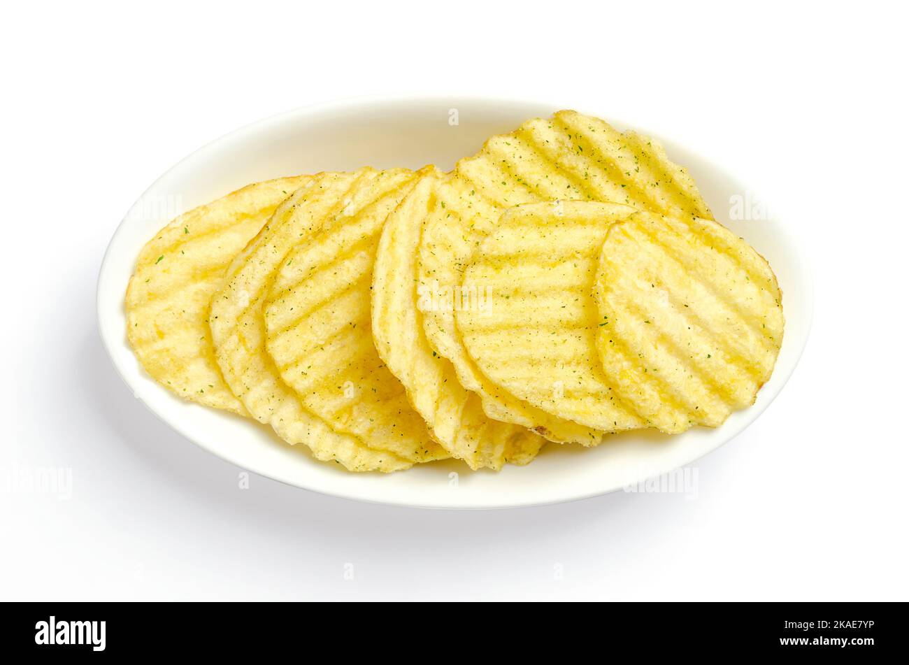 Wasabi and nori flavored salted ruffles, ruffled potato chips, in a white bowl. Crinkle-cut potatoes, deep fried in oil until crunchy. Stock Photo