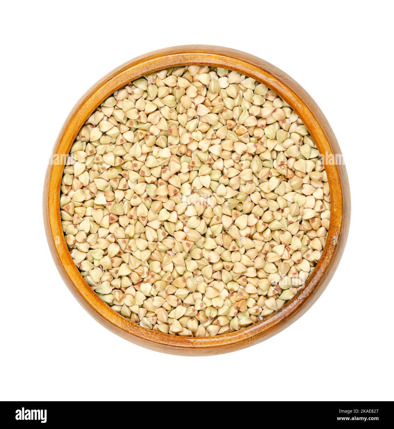 Common buckwheat grains in a wooden bowl. Hulled seeds of Fagopyrum esculentum, also known as Japanese or silverhull buckwheat. Stock Photo
