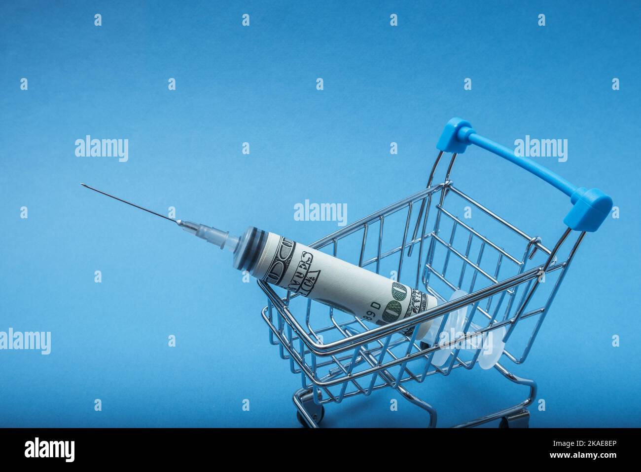 The syringe wrapped in a dollar is in the basket. Offering a financial