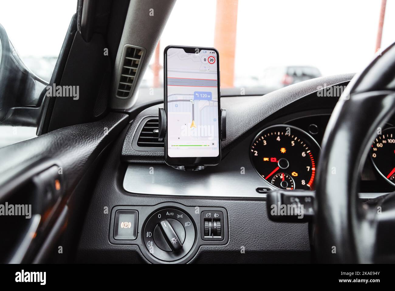 Smartphone with navigation route on screen mounted on phone holder at car dashboard Stock Photo