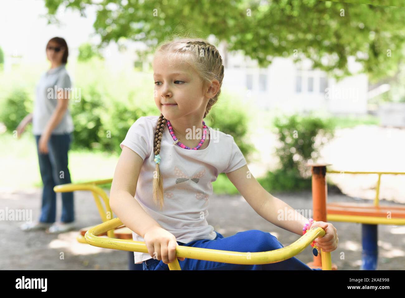 Portrait of a beautiful girl on the playground at a swing Stock Photo ...