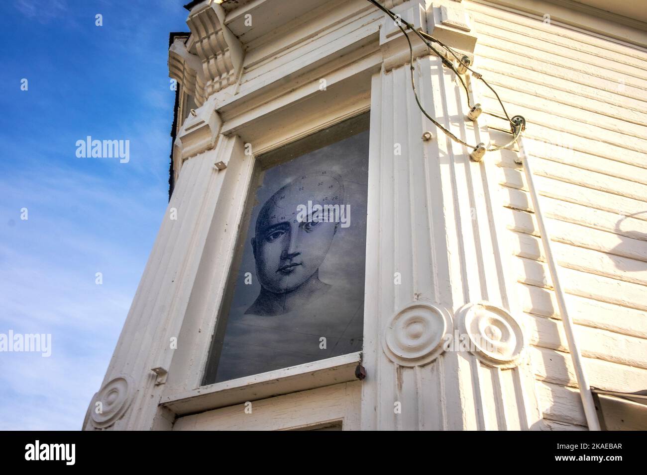 Face on a wall, antique shop, Edison, Washington, USA Stock Photo