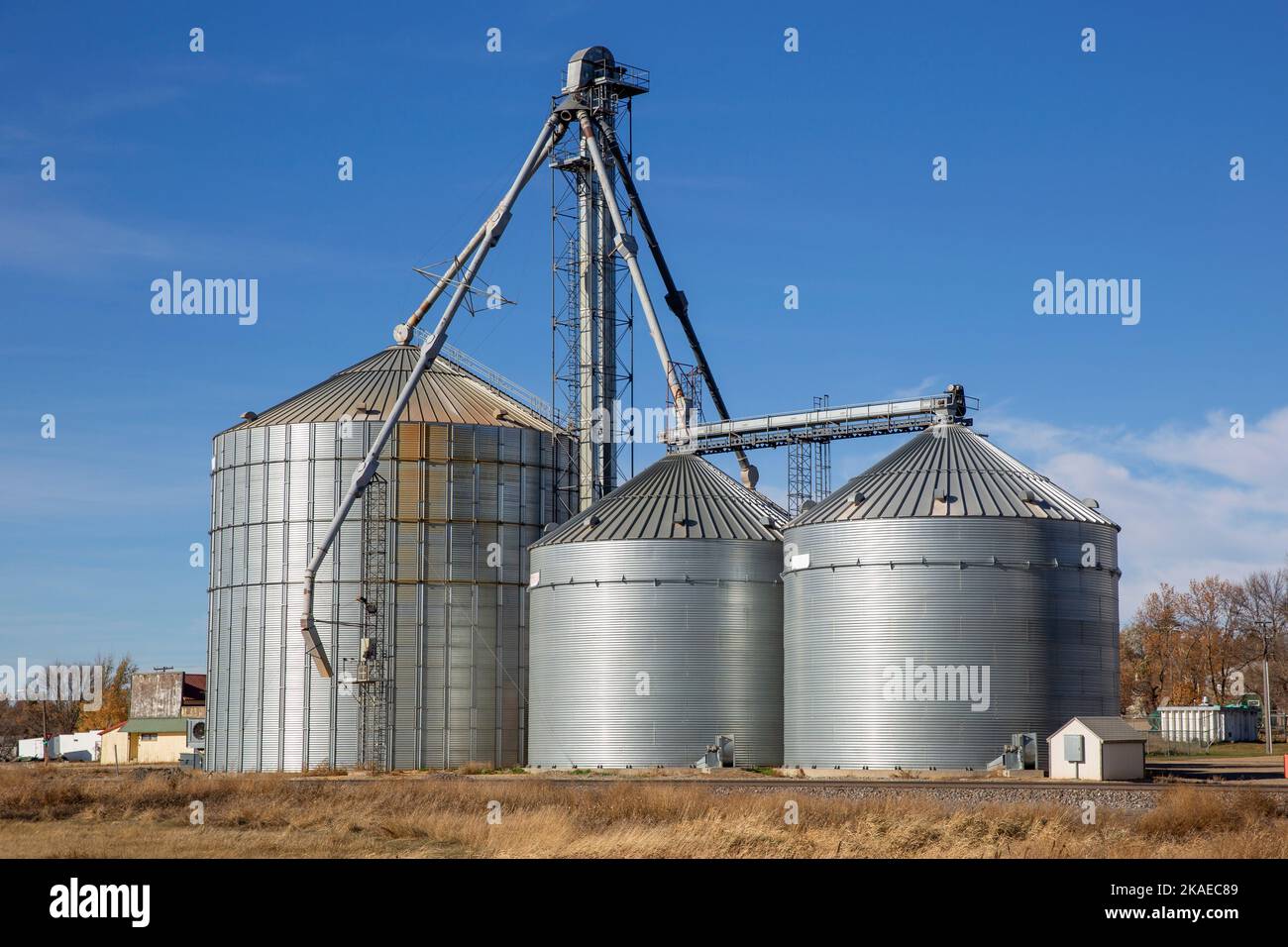 Three conical shaped metal bins used for storage of agricultural crops