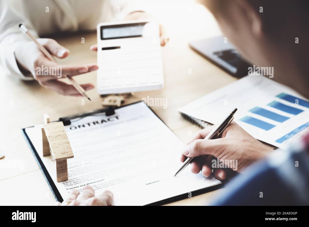 estate agent gives pen and documents agreement with customer to sign contract. Concept agreement. Stock Photo