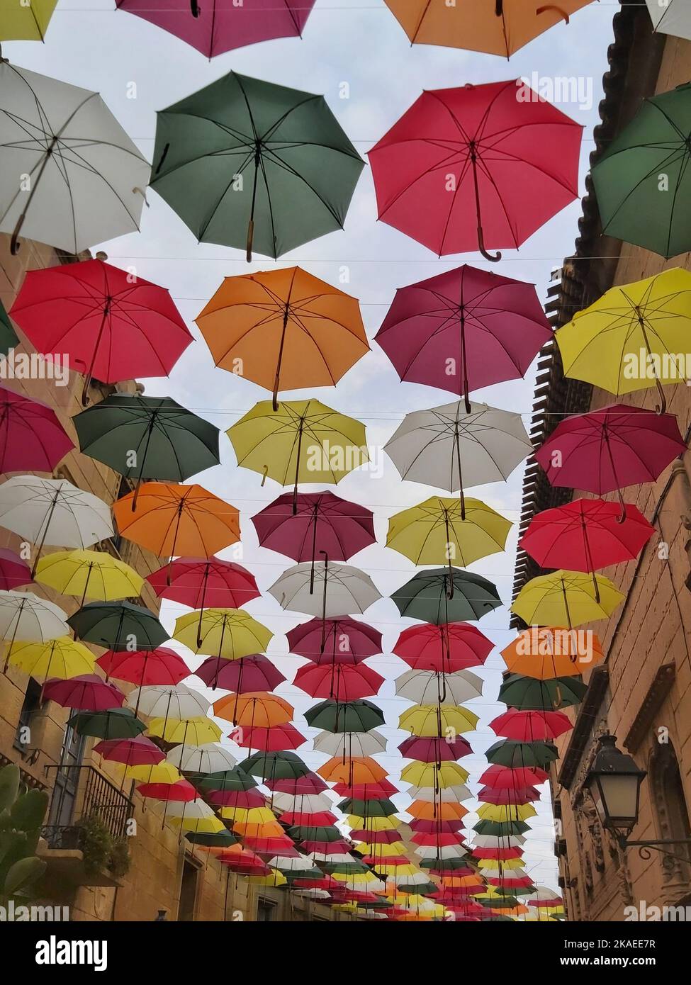 The colorful umbrellas hanging across a typical street in the city