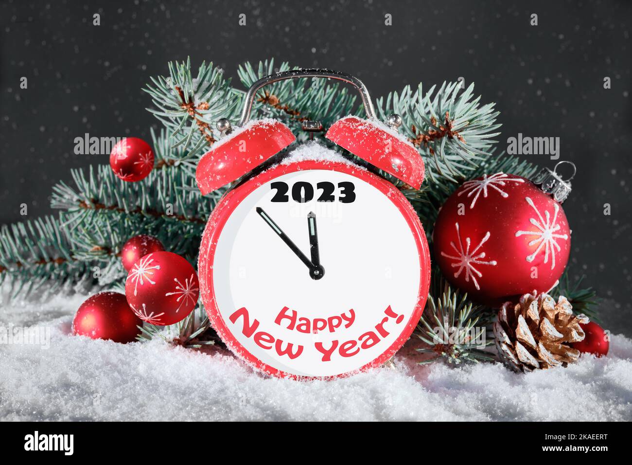 Year 2022 changes to 2023. Wintage alarm clock with fir twigs, cones