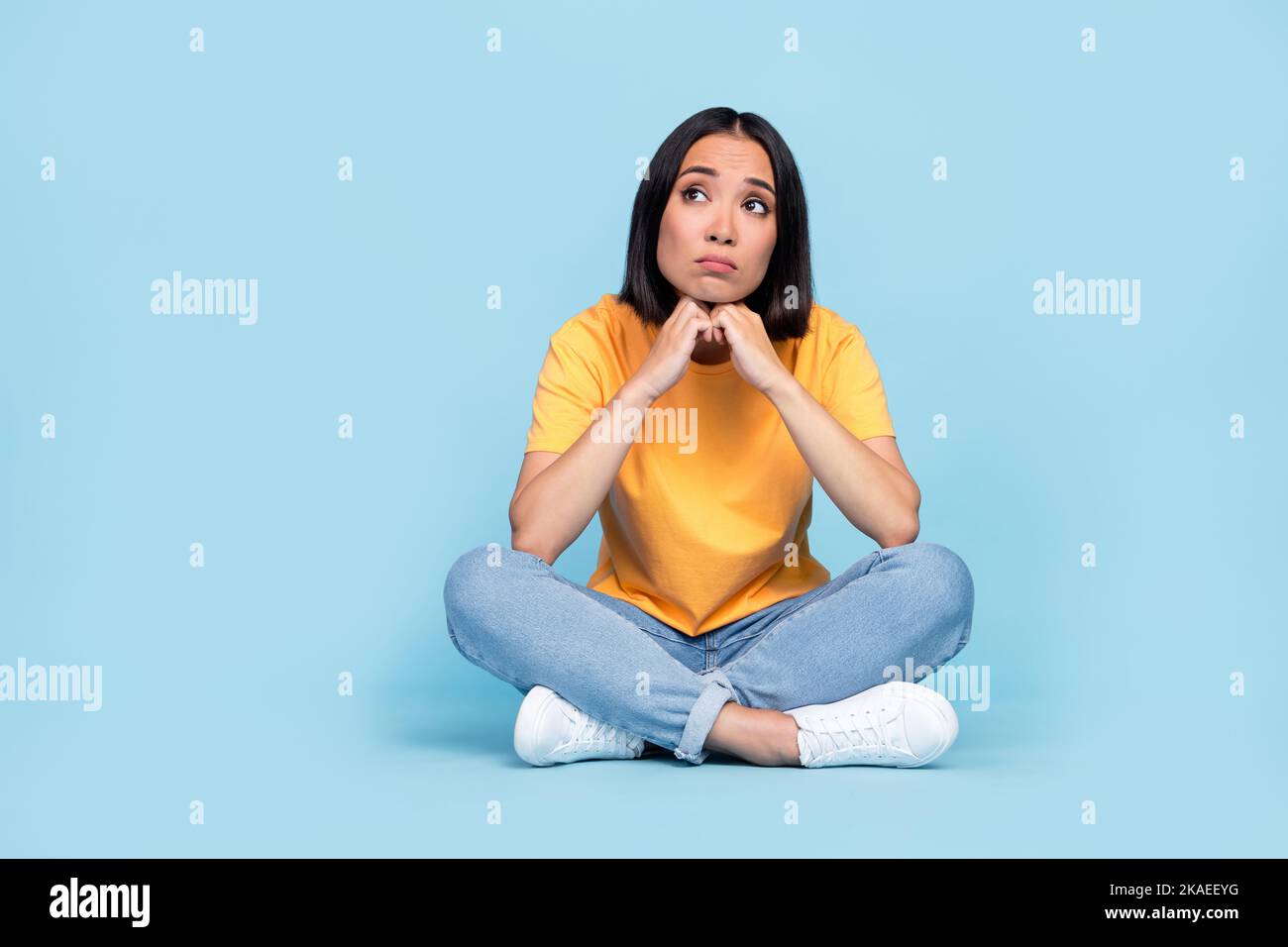 Full body photo of lovely young girl chinese sit floor sad