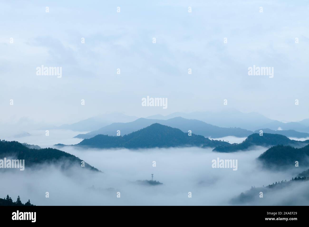 An aerial view of forested mountains covered by fog Stock Photo - Alamy