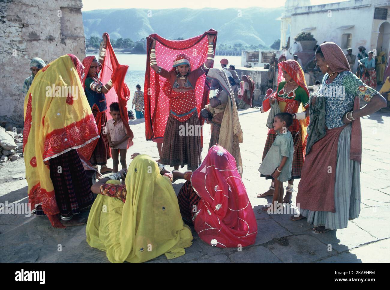 India. Rajasthan. Pushkar. Local women in saris with children. Stock Photo
