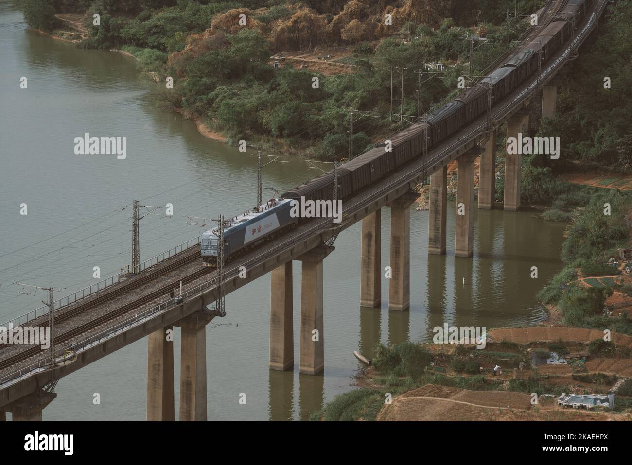 A beautiful aerial view of a train crossing a bridge over the Yangtze River in Jiujiang, China Stock Photo