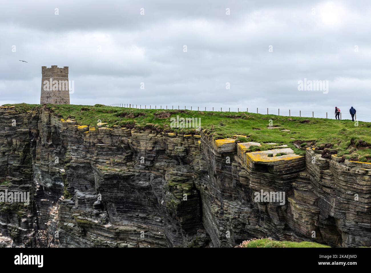 Two tourists walking to Marwick Head and Kitchener Memorial, Orkney, Scotland, UK Stock Photo