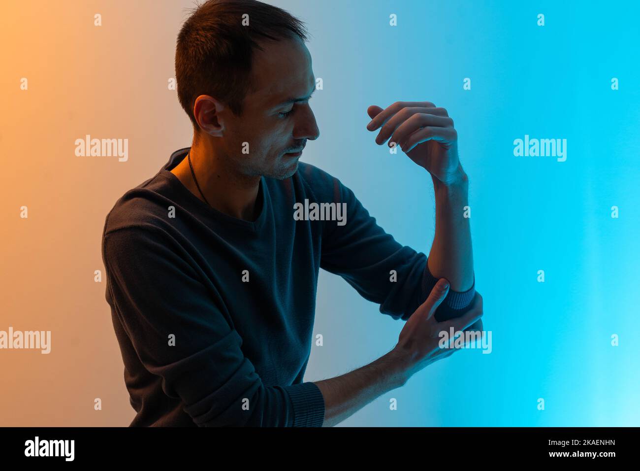 the man's arm hurts colored background Stock Photo Alamy