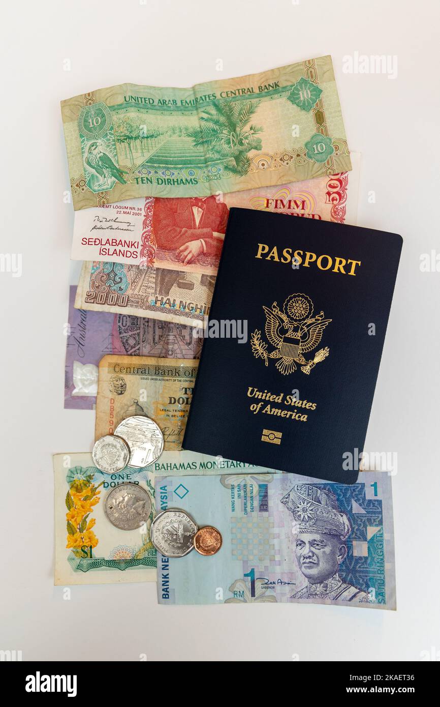 US passport and foreign paper currency Stock Photo