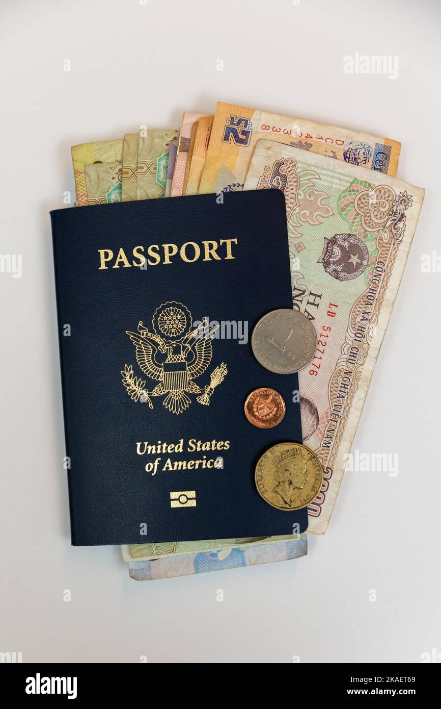 US passport and foreign paper currency Stock Photo
