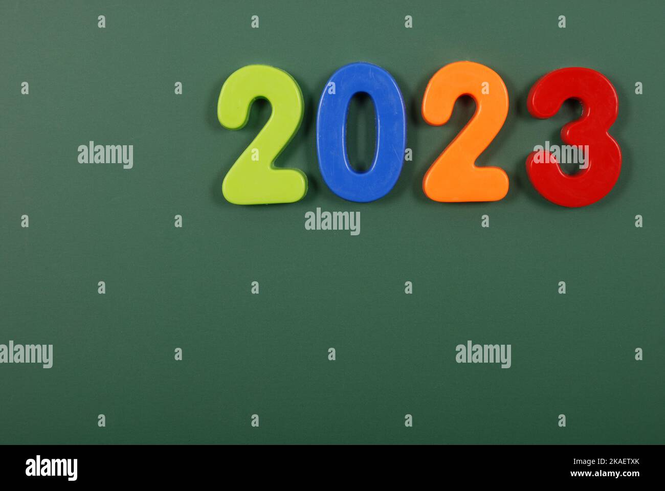 2023 year written in bright plastic magnetic letters stuck on a ...