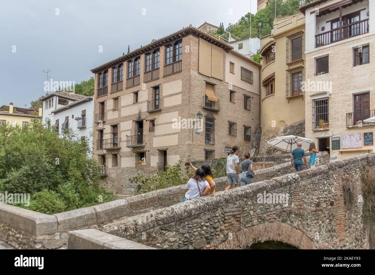 Granada Spain - 09 14 2021: View at the Darro Street, Paseo de los tristes, cabrera bridge, touristic people visiting iconic and picturesque street, A Stock Photo
