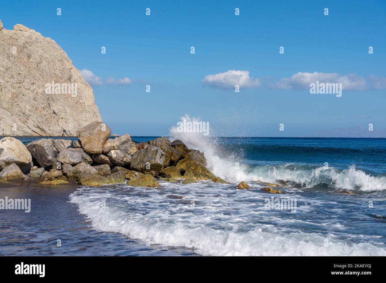 The waves splashing the rocks of the beach Stock Photo - Alamy