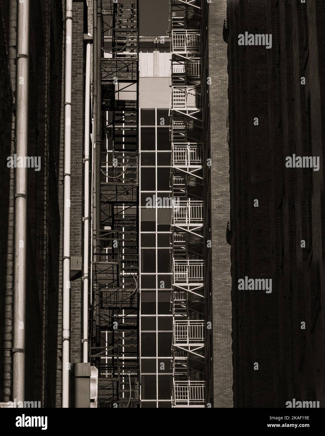 A vertical grayscale of a the buildings with balconies Stock Photo - Alamy