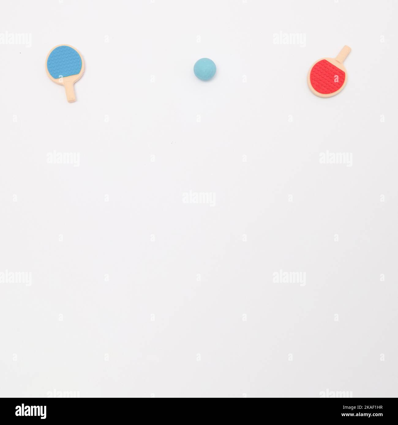 The red and blue table tennis rackets with a blue ball on a white ...