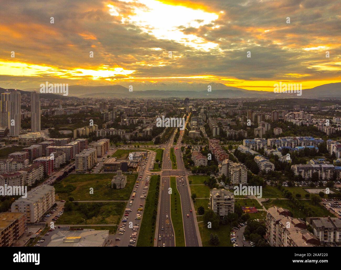 An aerial view of cityscape with long highways in the middle during ...
