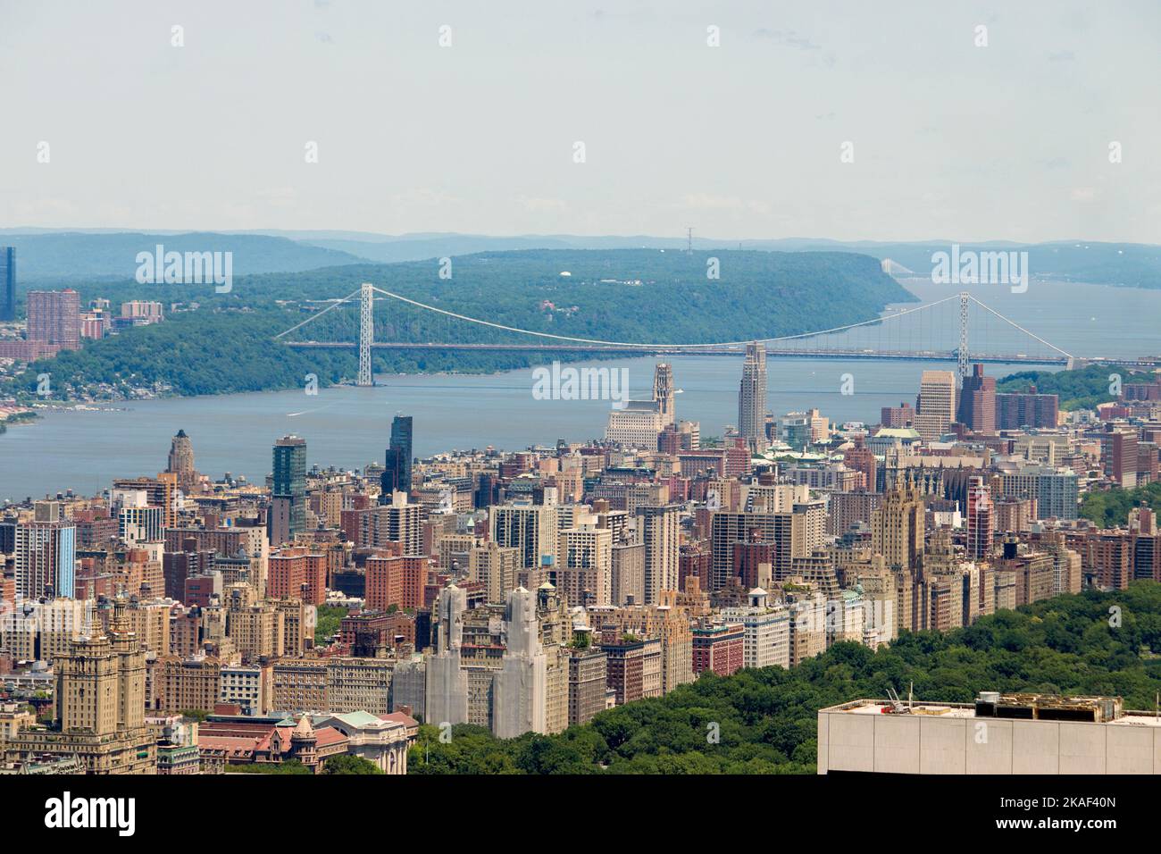 An aerial view of New York City with high skyscrapers and a bridge in ...