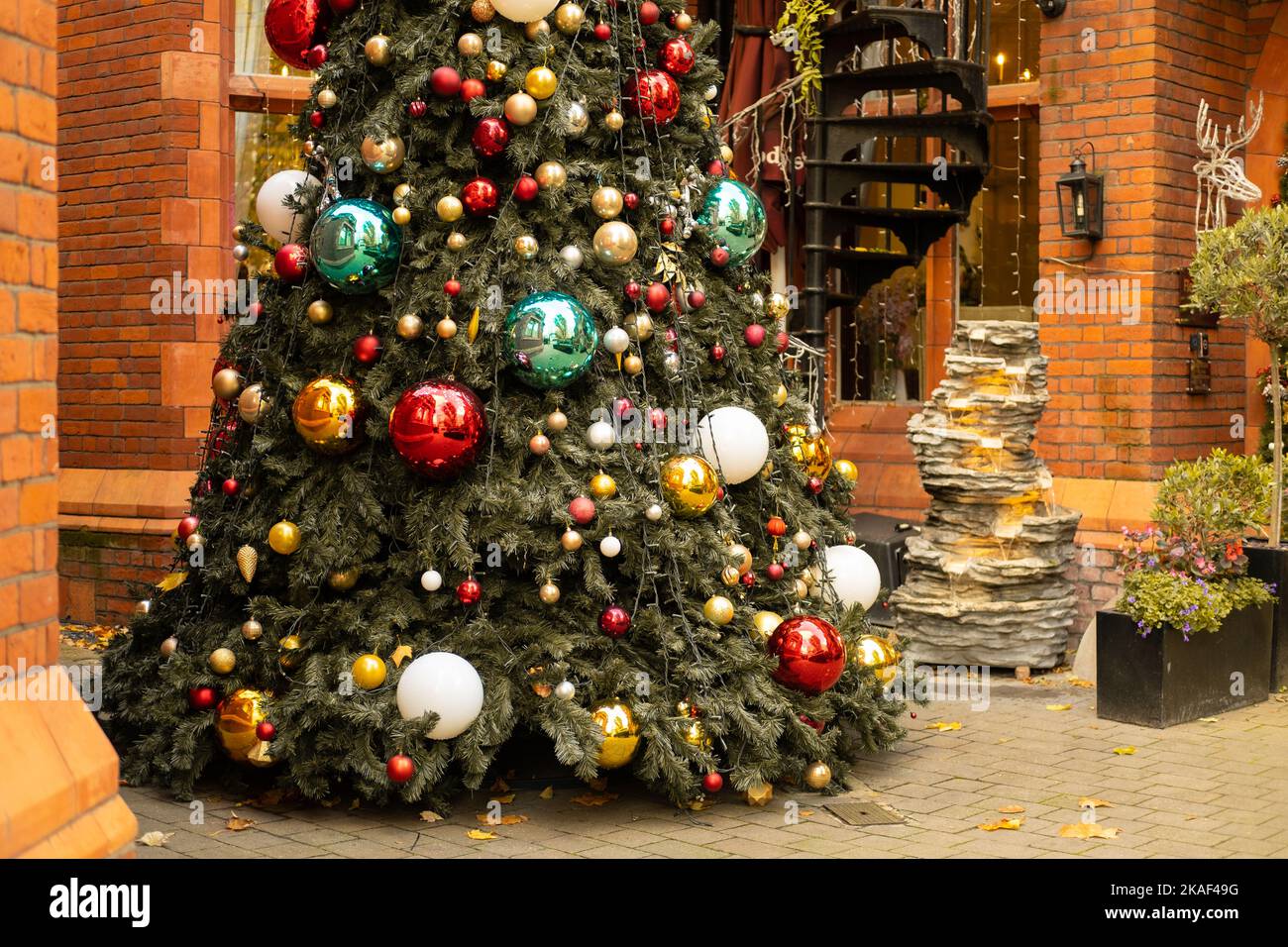 Partial view of a decorated Christmas tree and a fountain outdoors Stock Photo