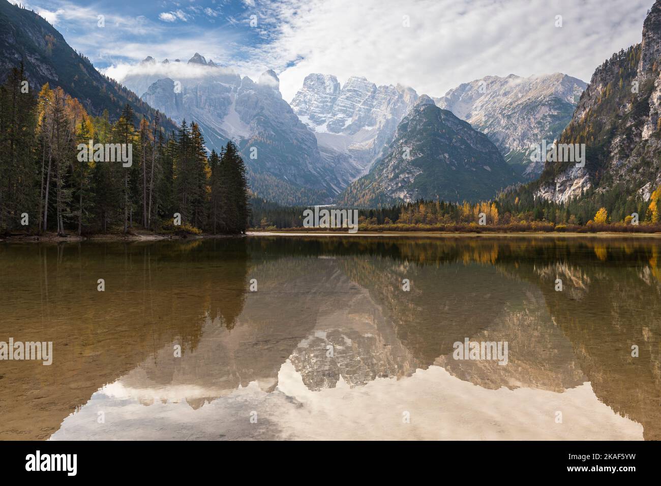 Reflection of the Cristallo mountain massif and autumnly colored mountain forests in Lake Dürren,South Tyrol, Italy Stock Photo