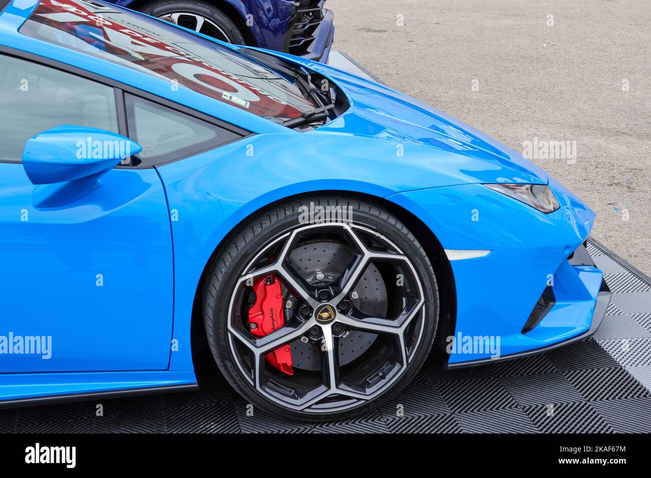 a-closeup-of-a-blue-sports-car-lamborghini-standing-on-the-road-stock