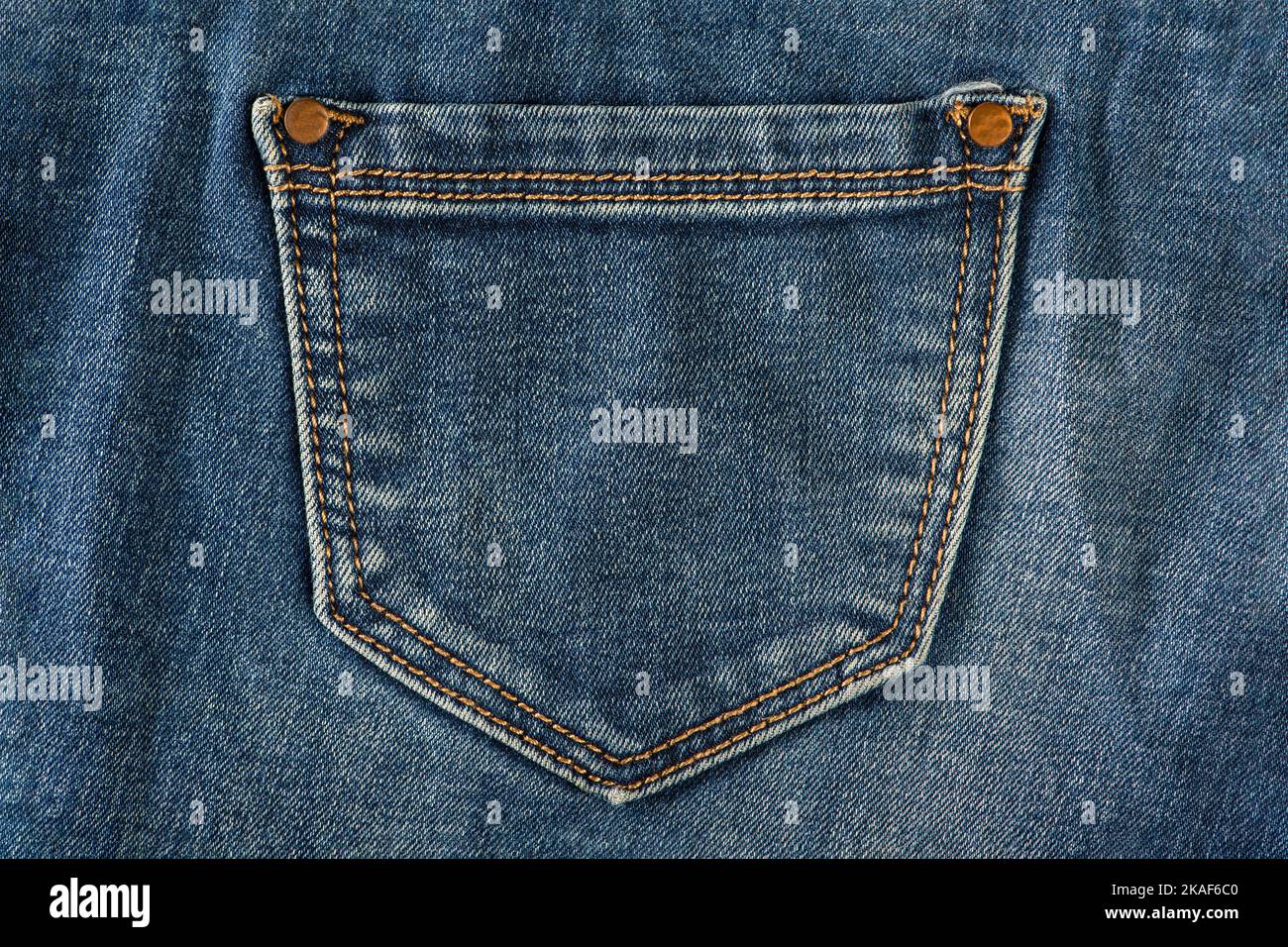 Pocket of old jeans. Empty back pocket of old blue jeans close-up. Stock Photo