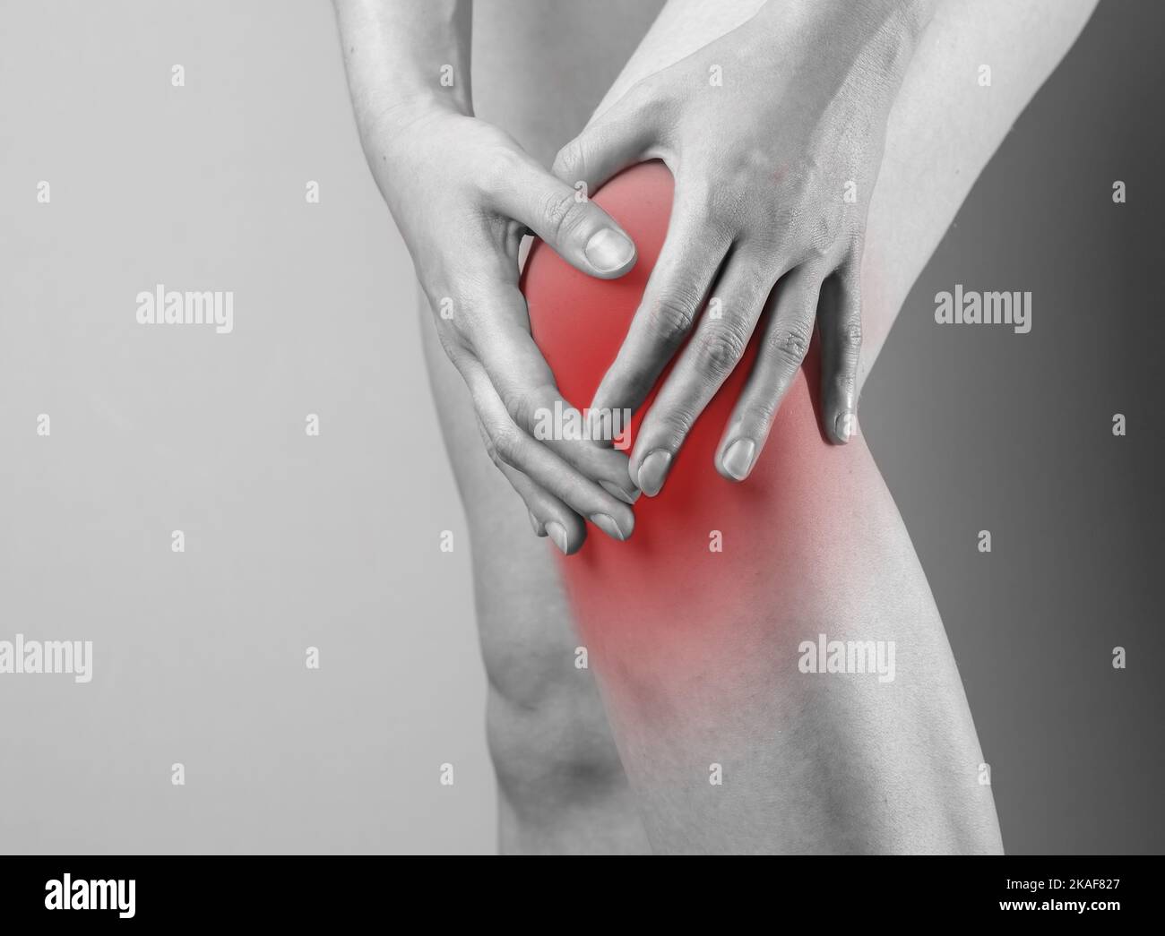 Knee cap, meniscus pain, trauma close up. Hand touching injured red