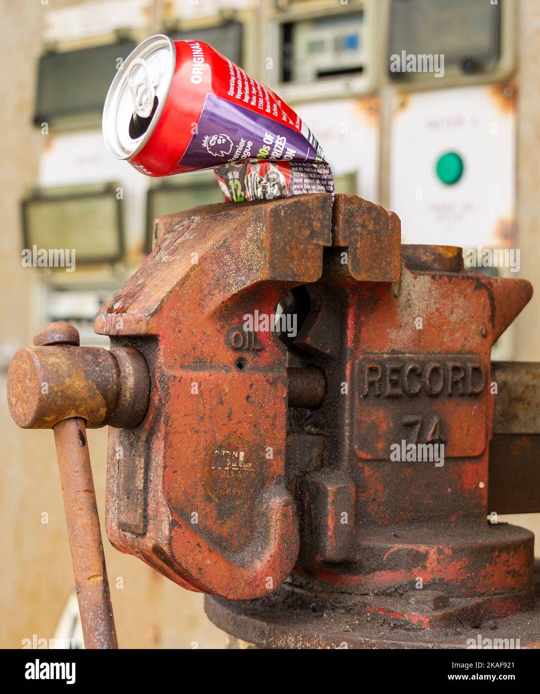 Record 74 Vice holding crushed tin can Stock Photo