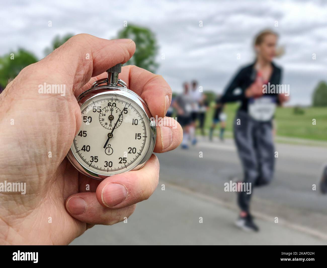 keeping time for runners in marathon race Stock Photo