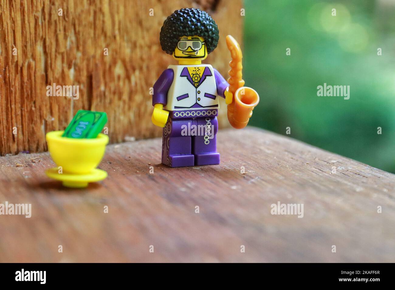 A Lego Toy male figure smiling character with an afro goatee Wearing funky glasses with saxophone Stock Photo Alamy