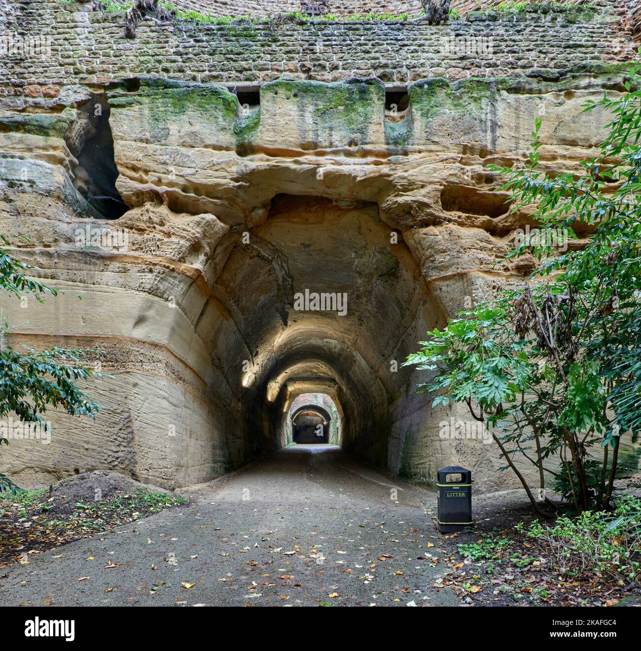 Lower entrance to Park Tunnel, showing part stone-lined wall and unlined sandstone, with shaft and upper tunnel in distance Stock Photo