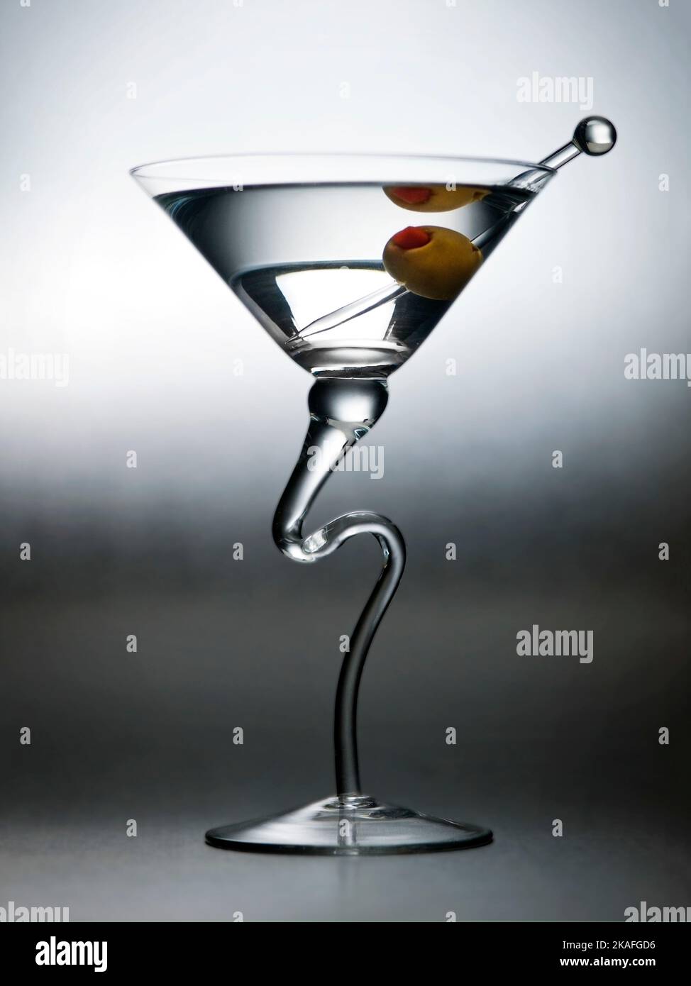Artistic Martini Glass with One Olive and Skewer Stock Photo
