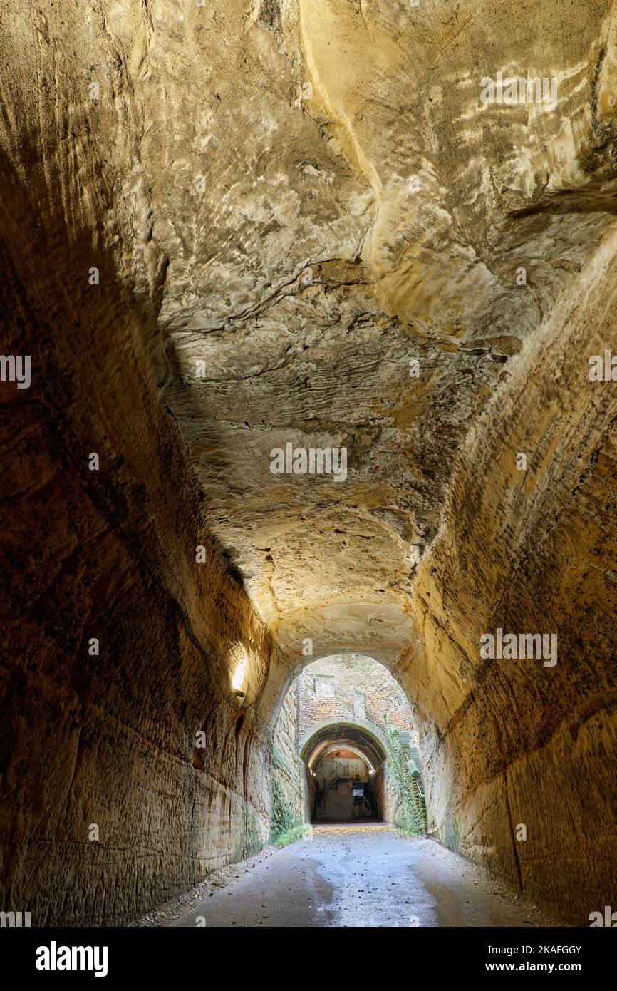 Unlined rock roof of lower Park Tunnel with shaft and upper tunnel in distance Stock Photo