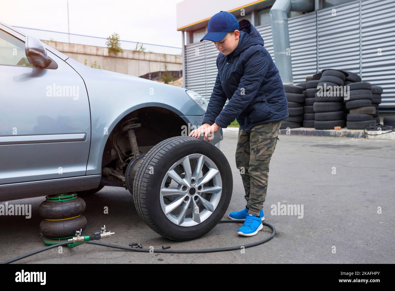 Mechanic man change a wheel tyre and service maintenance the suspension