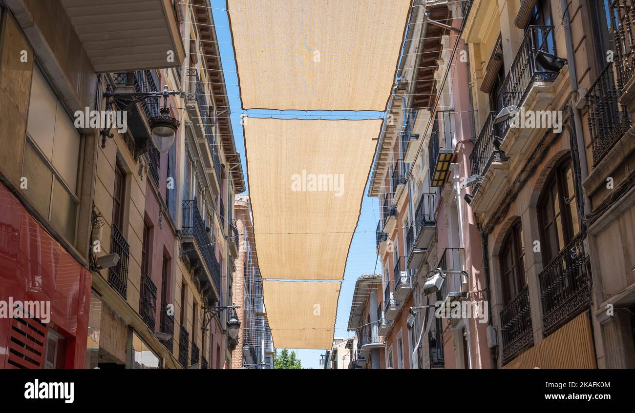 Toldos de tela entre edificios para proteger del sol durante los dÃas calurosos de verano en la ciudad de Granada, EspaÃ±a Stock Photo